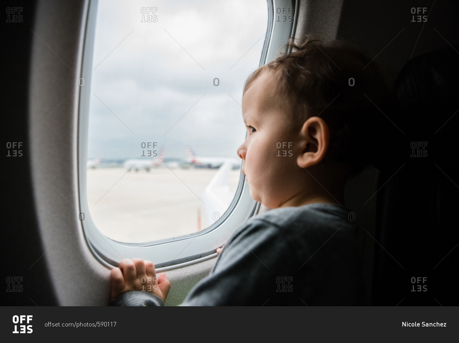 Baby looking out airplane window