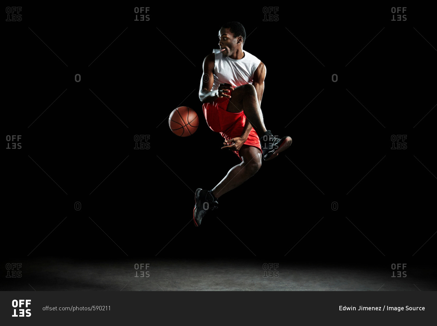 Young male basketball player mid air