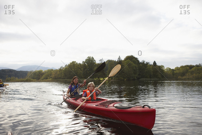 Family canoeing on lake, Staffelsee, Murnau, Oberbayern, Bavaria, Germany