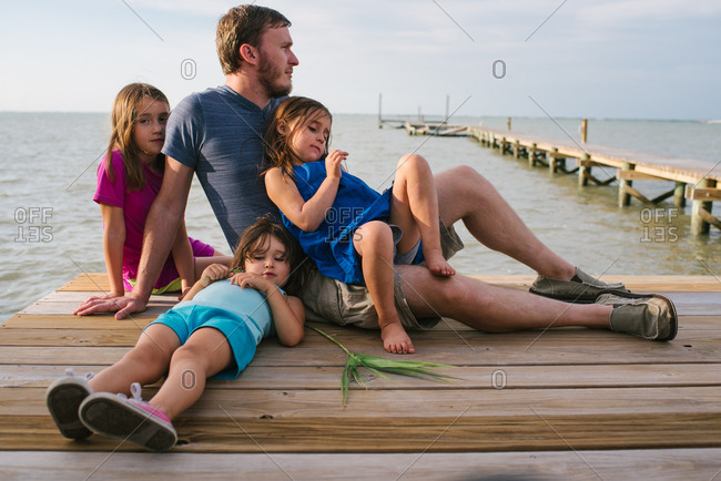 Dad with three girls on dock