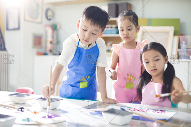 Little children painting in art class