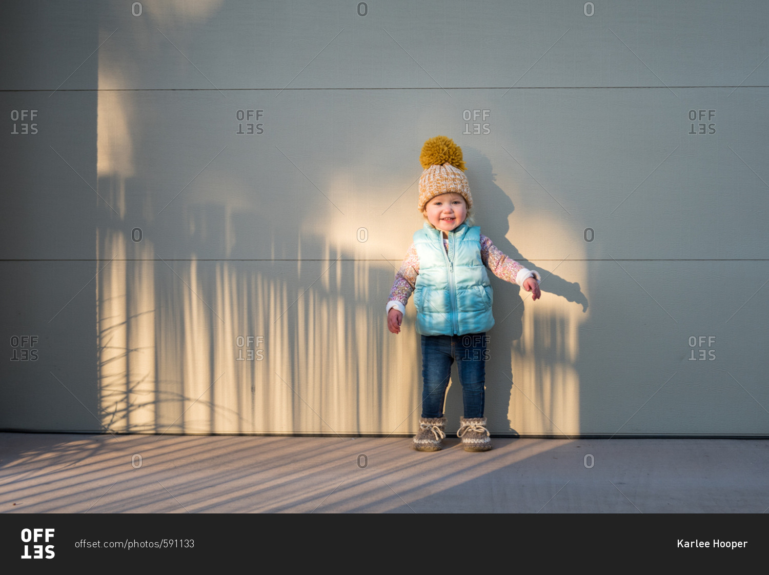 Toddler in sunlight in cold weather clothes