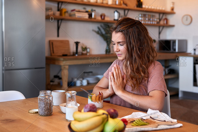 Spiritual woman giving thanks for the food before eating