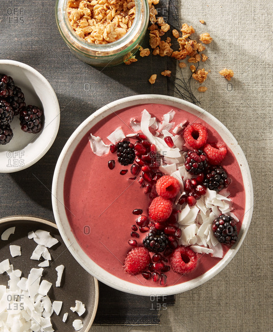 Overhead view of an Acai bowl with berries and coconut