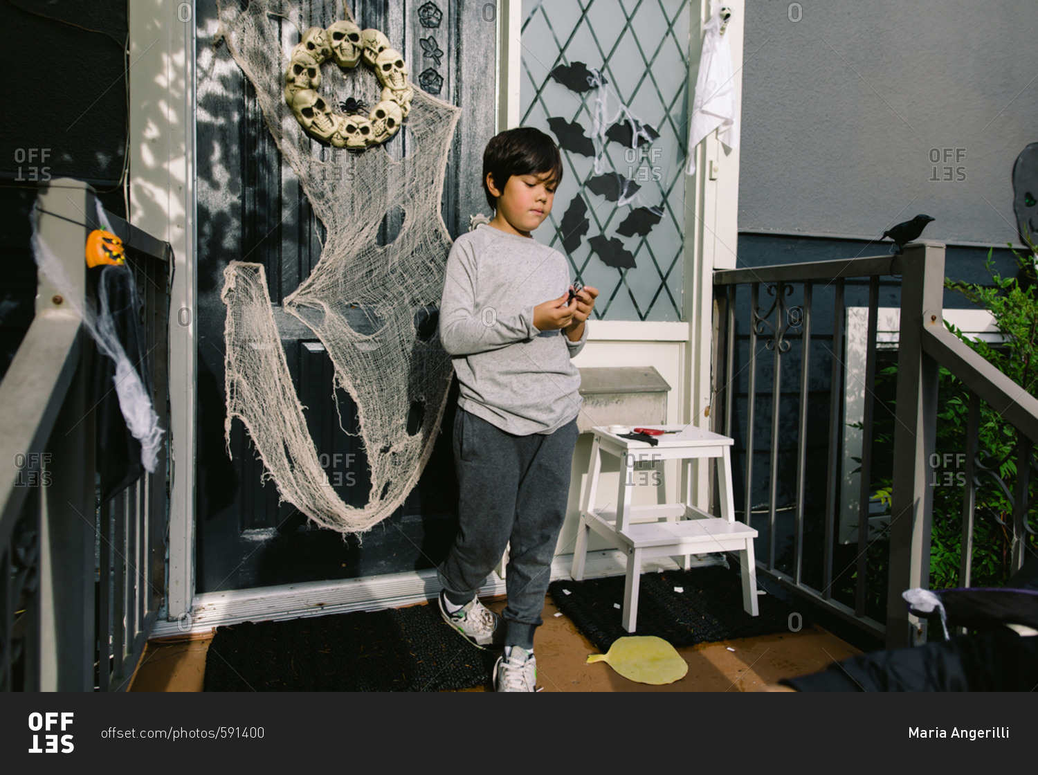 Boy decorating font porch for Halloween