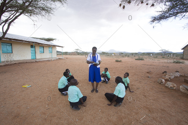 Isiolo, Samburu, Kenya - April 26, 2017: School teacher giving lesson to school girls outdoors at the Lorubae Primary School