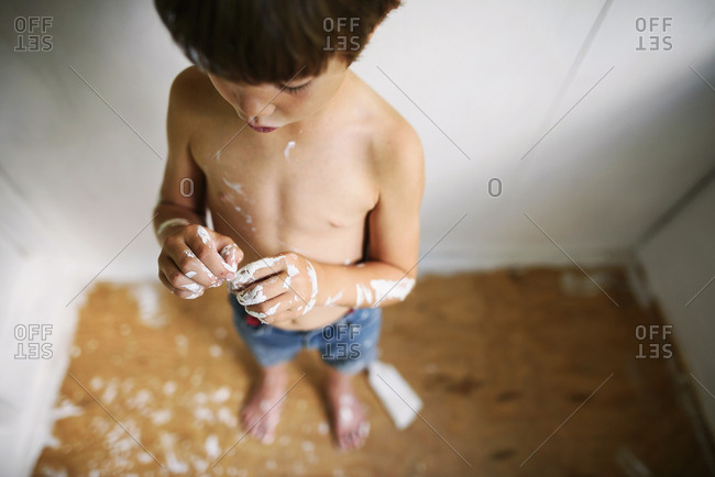 Overhead of child's messy painted hands