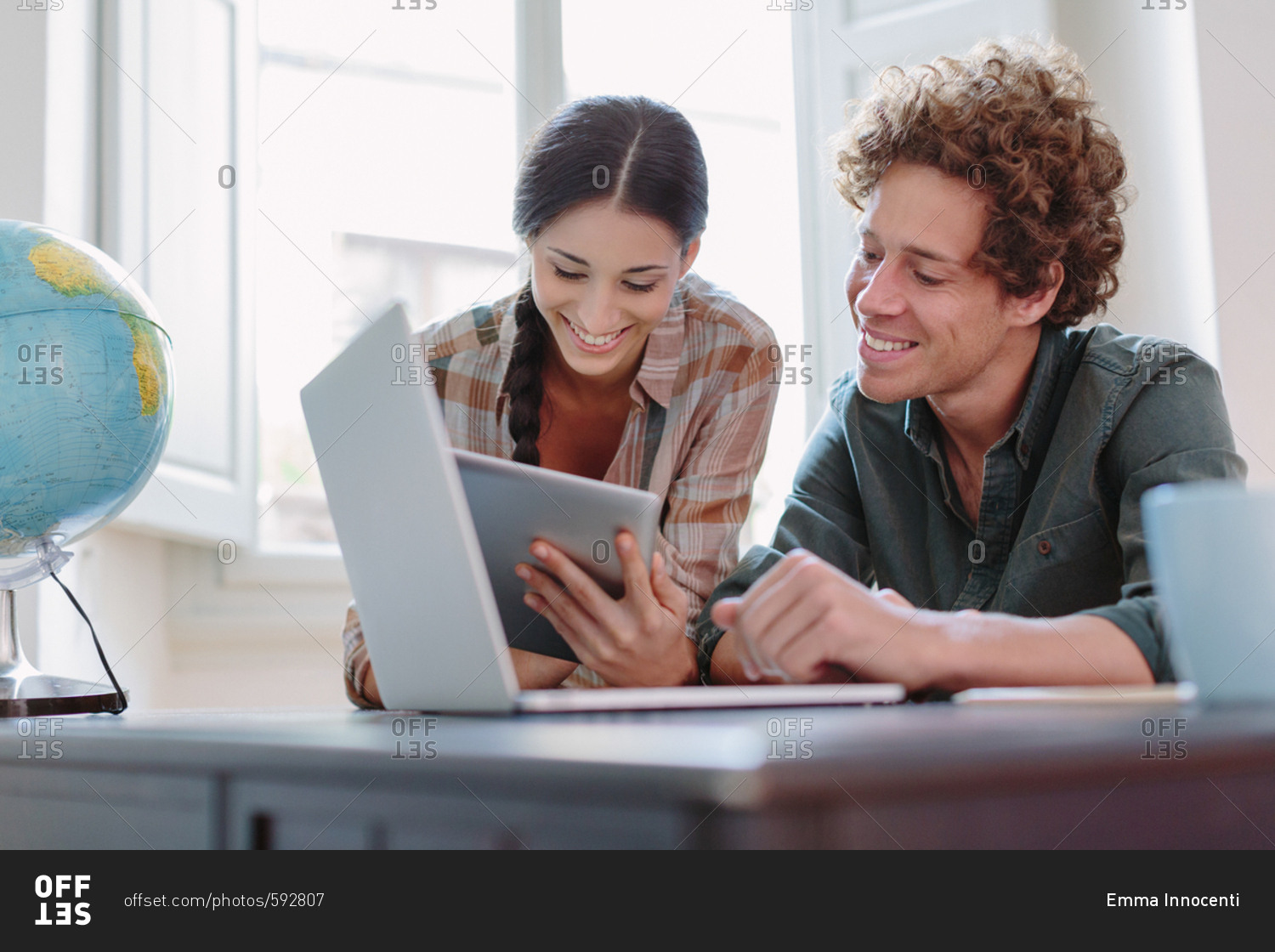 Happy young couple looking at a tablet