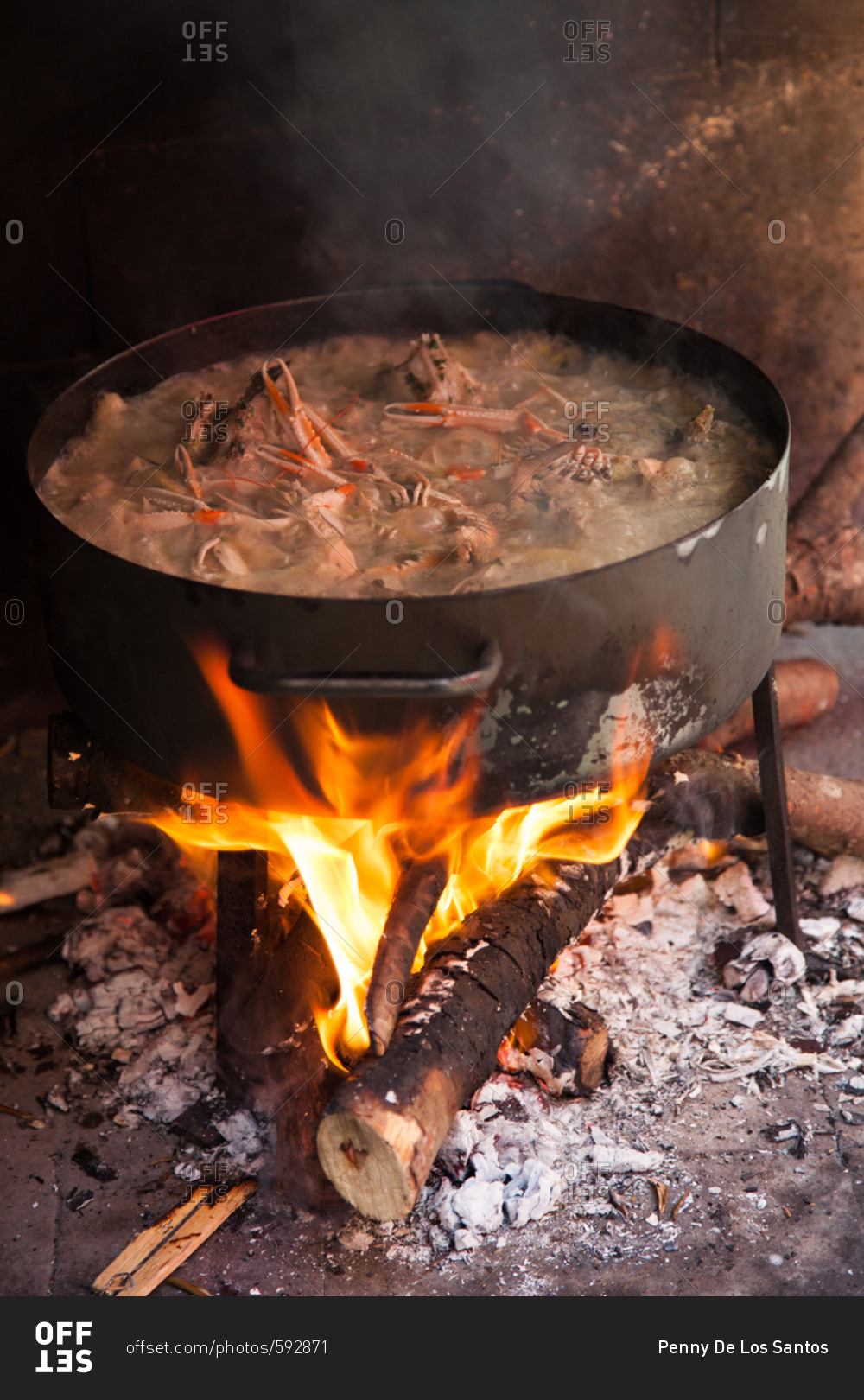 Seafood boiling in a large pot over an open flame