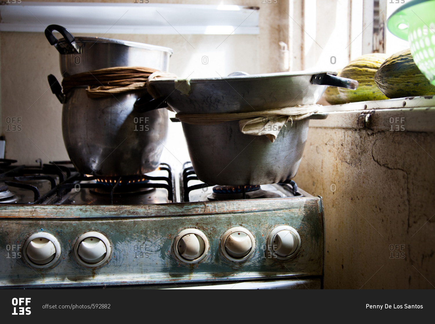 Cooking pots stacked on burners on a gas range in a Senegalese kitchen