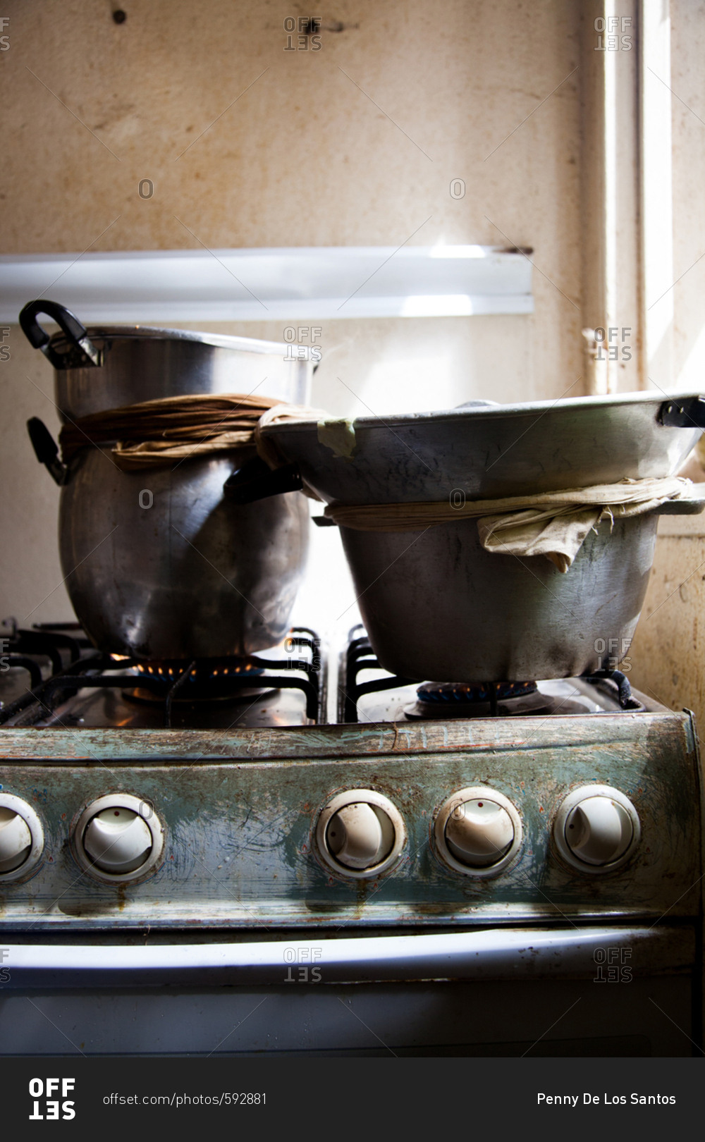 Pots of food cooking on a gas range in a Senegalese kitchen
