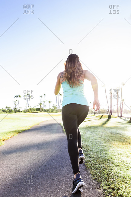 Hispanic woman running on path
