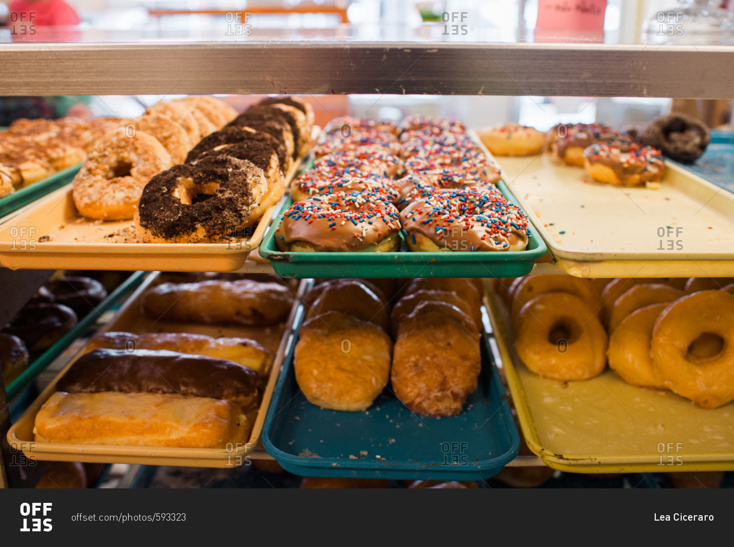 Donut varieties in a display case stock photo - OFFSET