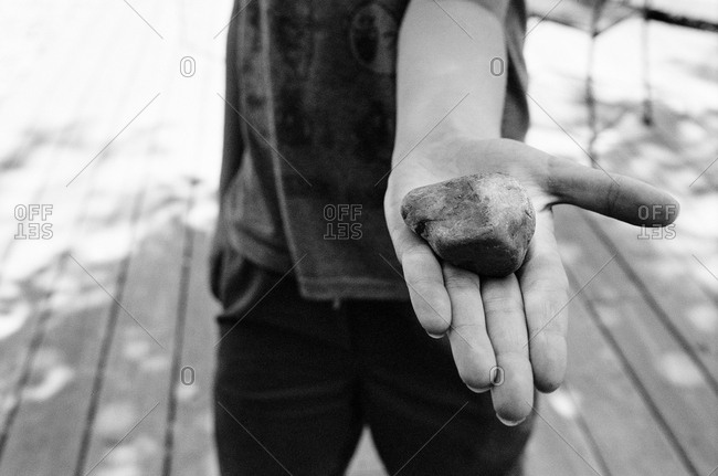 Child holding rock in hand