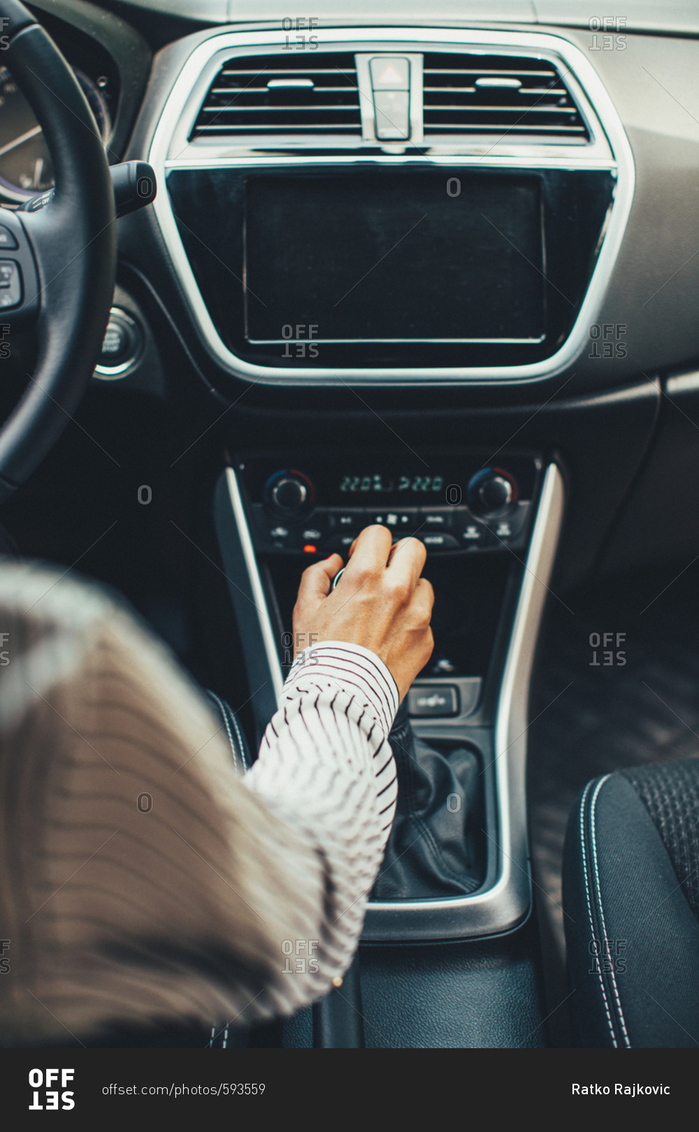 Woman\'s hand on stick shift of automobile