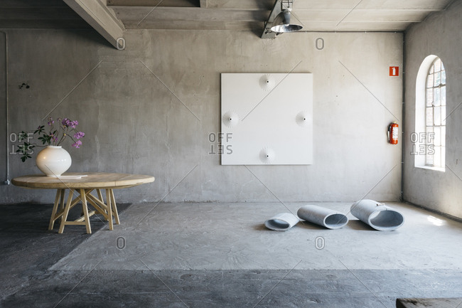 Antwerp, Belgium - June 2, 2017: Interior of home in Kanaal development in Antwerp, Belgium with a wooden table holding a vase