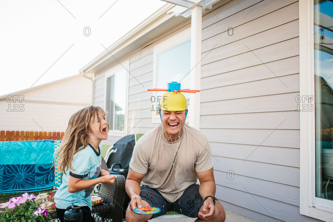 Dad and boy laughing with silly hat