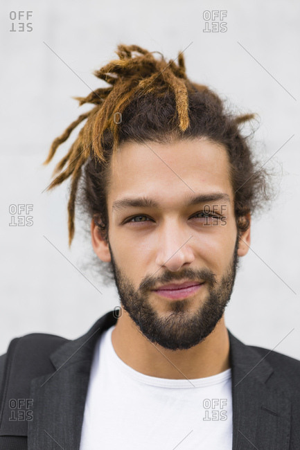 Portrait of young businessman with dreadlocks