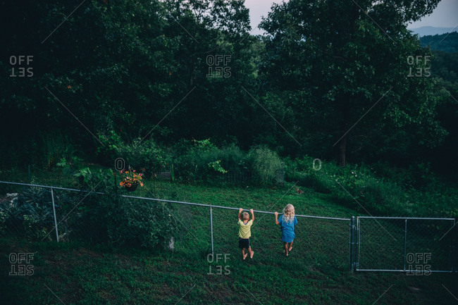 Kids climbing fence in Ozark mountains
