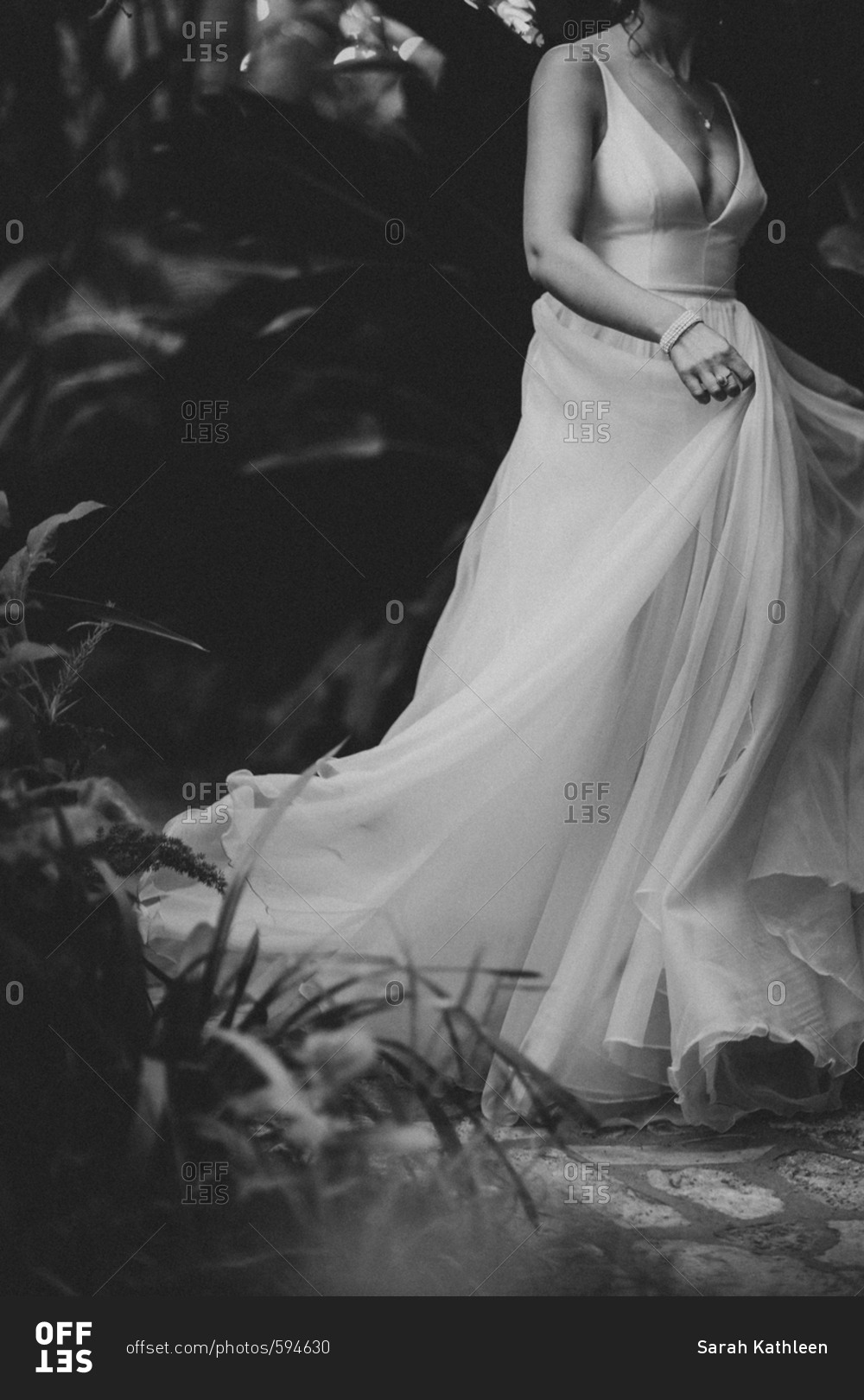 Bride walking with flowing dress in black and white