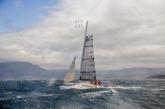 Johnstone Strait, British Columbia, Canada - July 21, 2017: Group of team members riding sail boat in johnstone strait