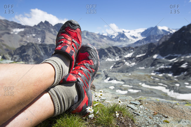 Trail running shoes are resting in the mountains of Switzerland. Halfway the Haute Route, a classic multi day hike in Switzerland.