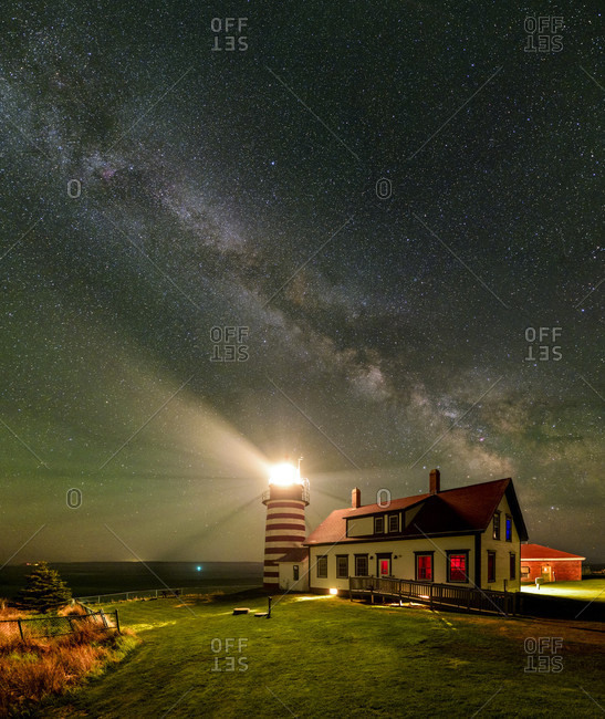 A vertical panorama of the Milky Way over West Quoddy Head Lighthouse in Maine.