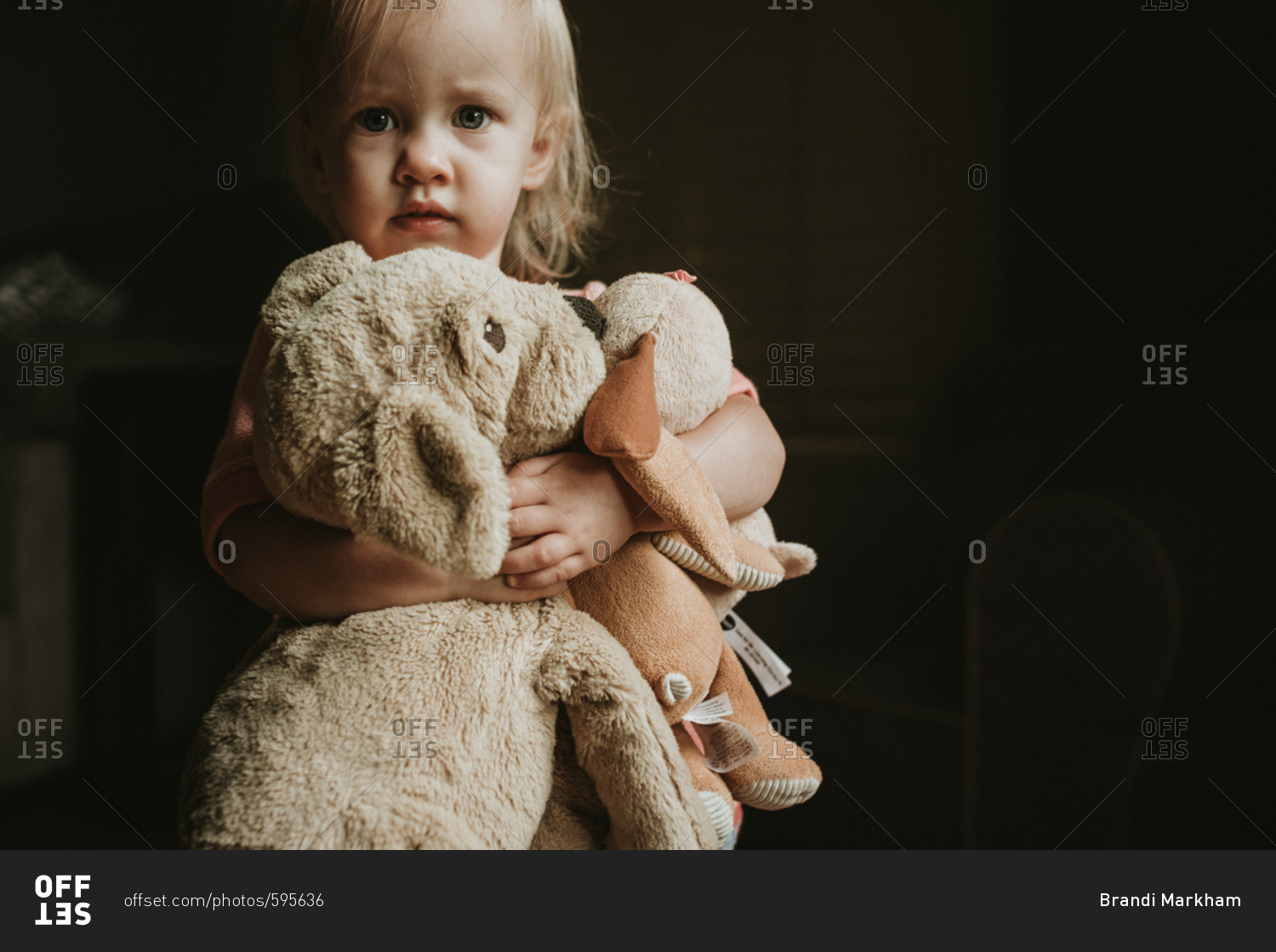 Little girl hugging stuffed animals