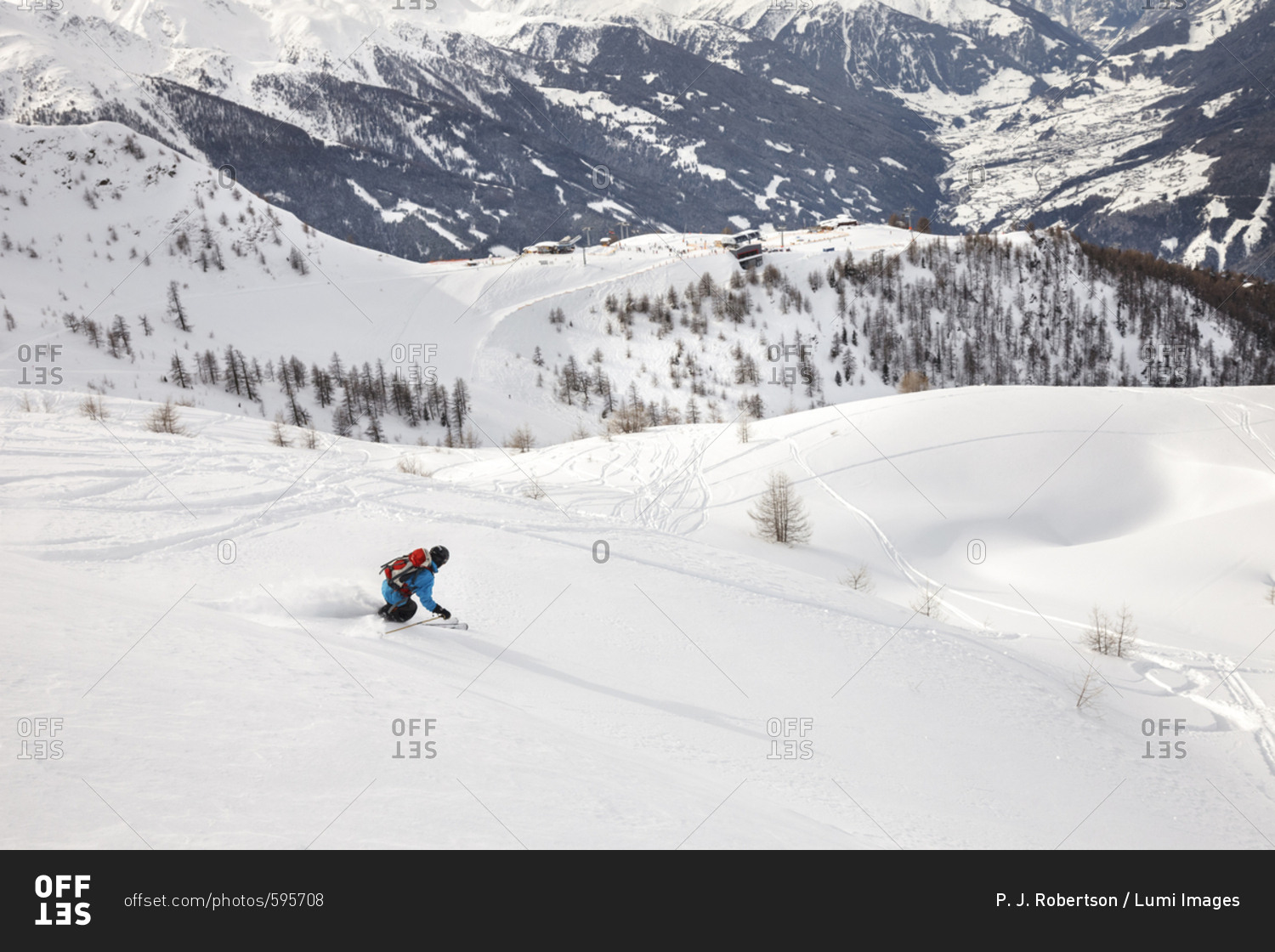 Man snowboarding downhill in powder snow