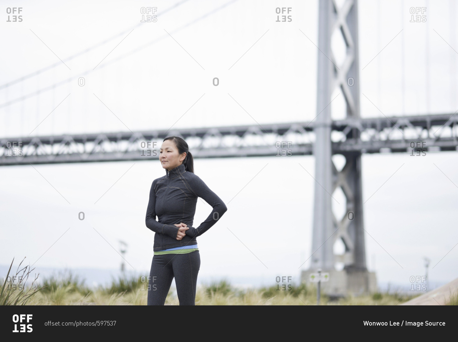 Female runner taking break by bridge, San Francisco, California - Stock ...