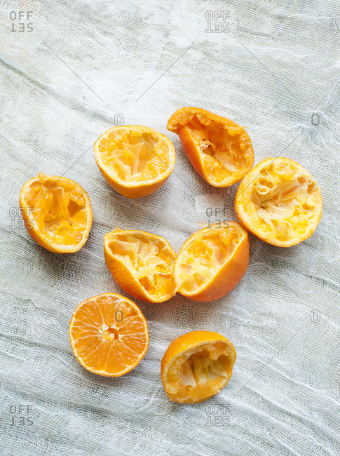 Freshly squeezed orange halves on muslin