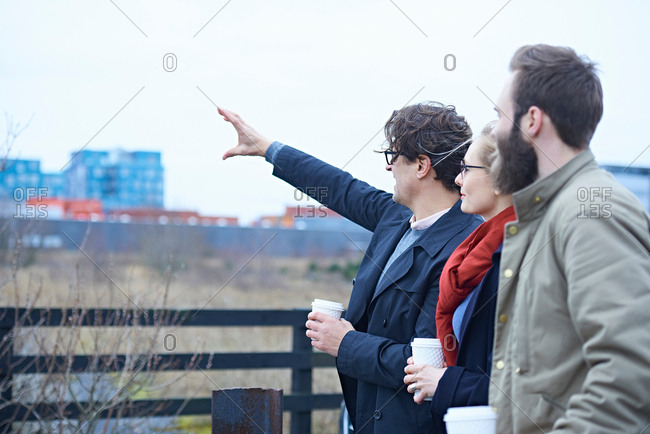 Rear view of design team pointing outside design studio