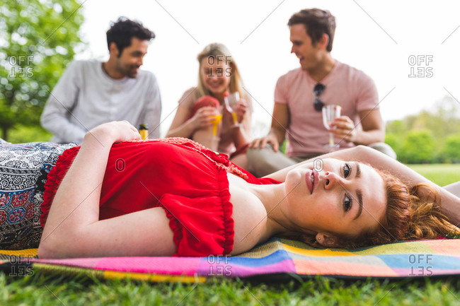 Group of friends relaxing at picnic in park