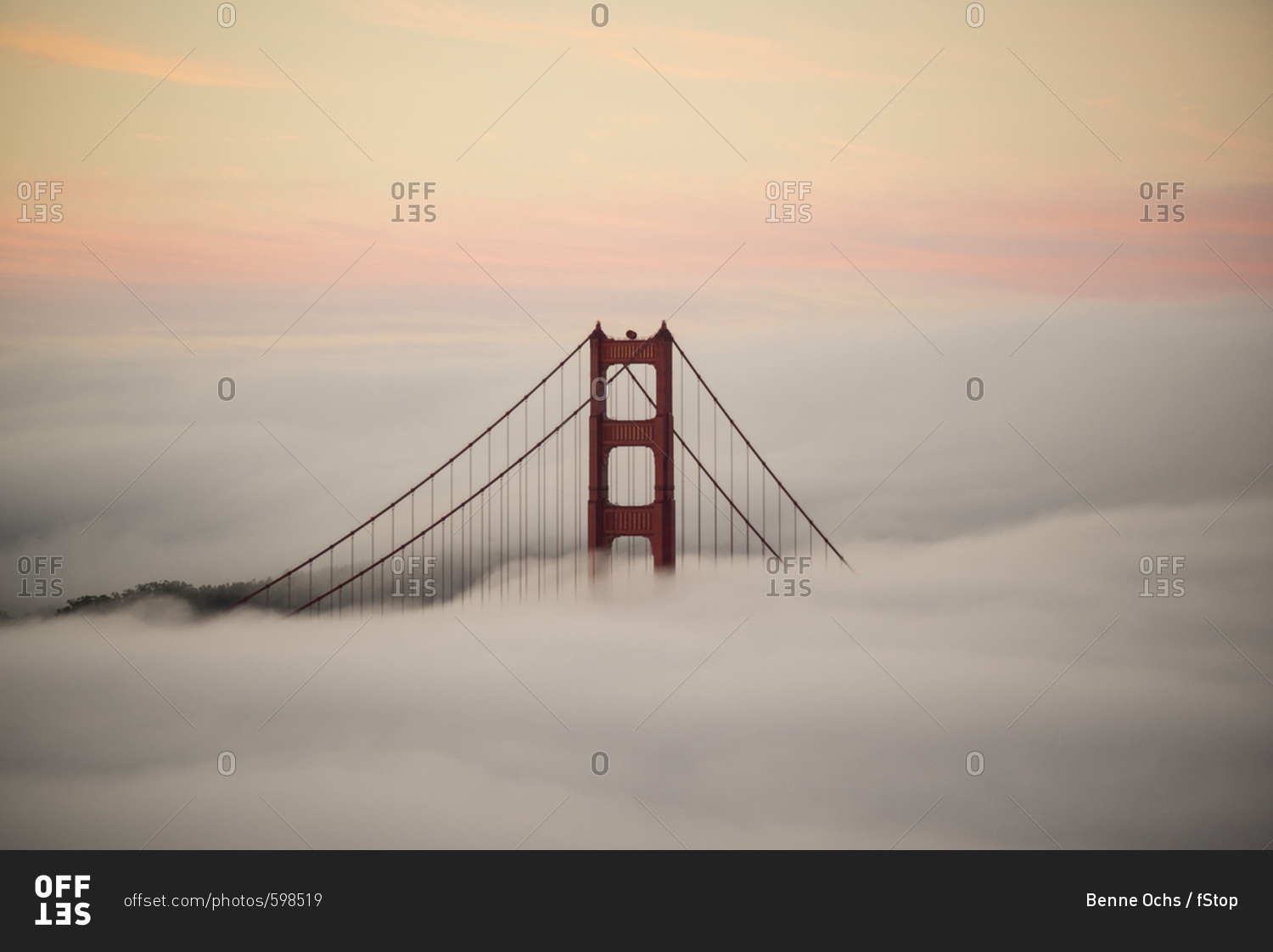 Golden Gate Bridge surrounded by fog during sunset, San Francisco, California, USA