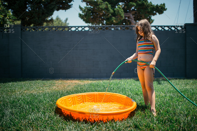 Plastic Swimming Pool Stock Photos Offset Filling Children S Plastic Pool With A Garden Hose
