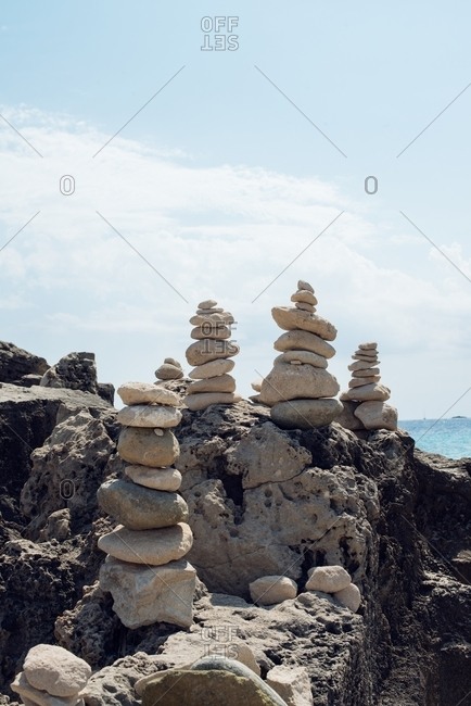 Cairns stacked on a stone surface at a beach