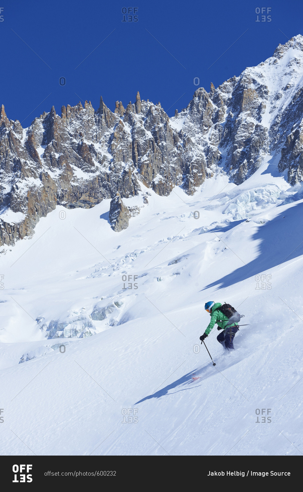 Male skier skiing steep downhill on Mont Blanc massif, Graian Alps, France