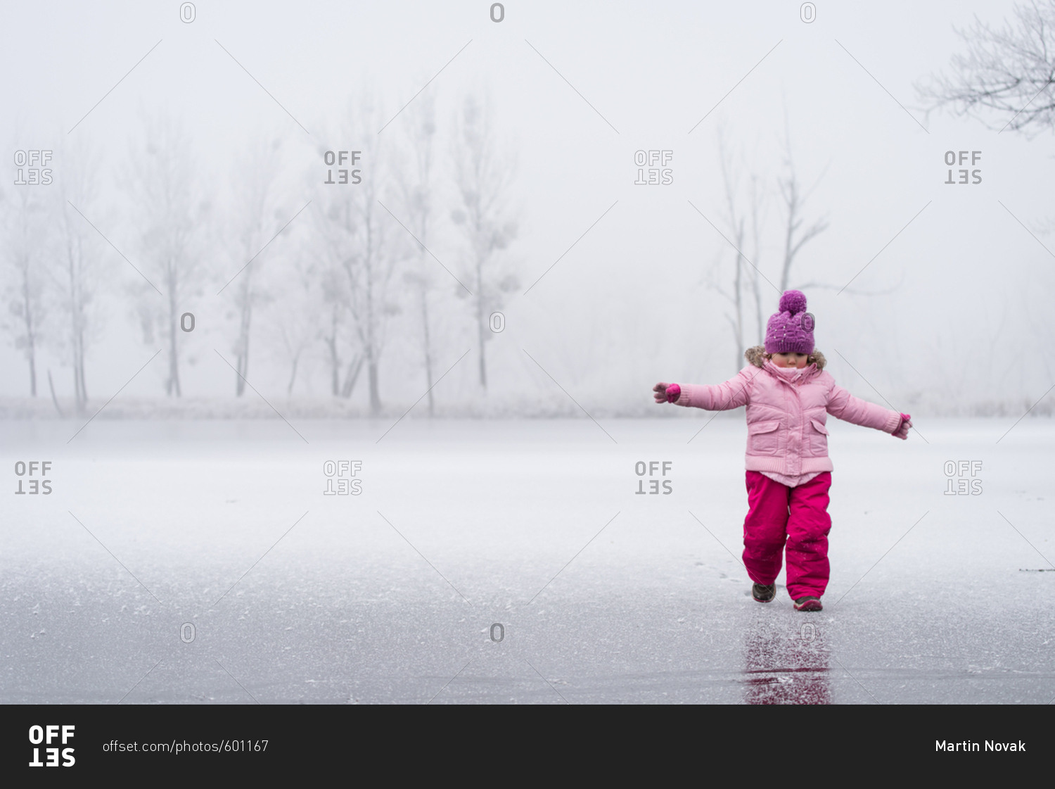 Little girl having some winter fun on the frozen lake