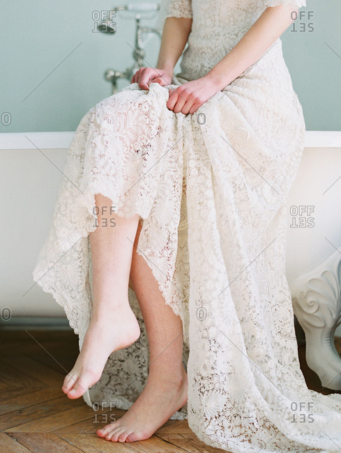 Woman in lace dress by tub