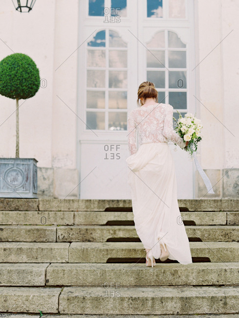 Bride going up chateau steps