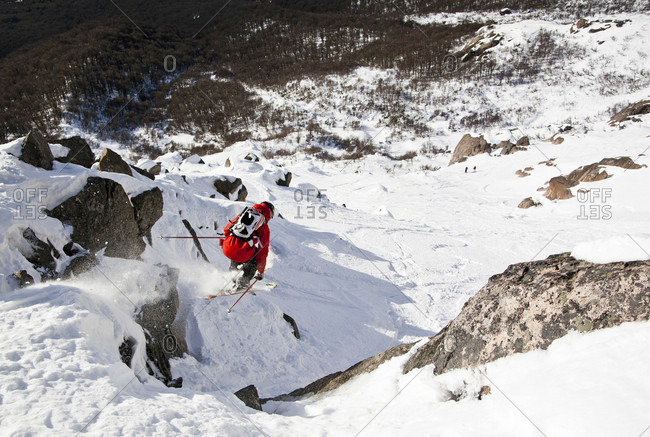 Sans Carlos De Bariloche, Rio Negro, Argentina - July 31, 2012: A Skier Jumping Off Cliff In The Backcountry Of Cerro Catedral In Argentina