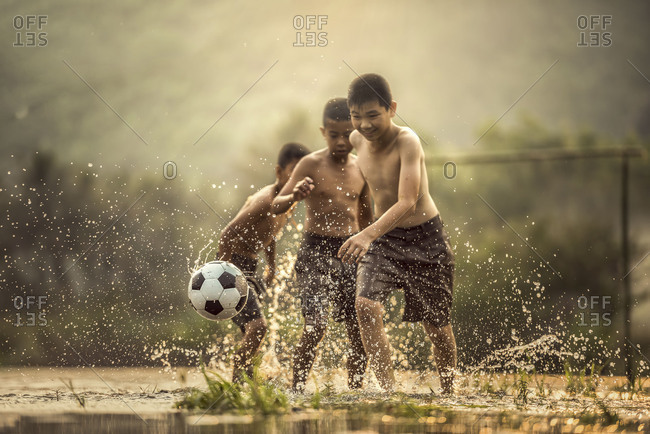 Boy kicking a soccer ball (Focus on soccer ball)