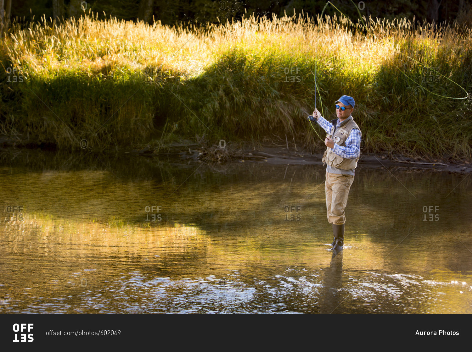 A man fly fishing on the North Fork of the Payette River in Idaho on a Fall morning