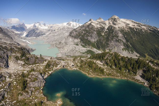 Aerial photograph of two different colored alpine lakes in British Columbia, Canada