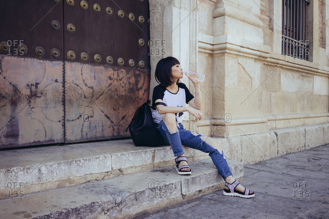 Tourist relaxing on stairs