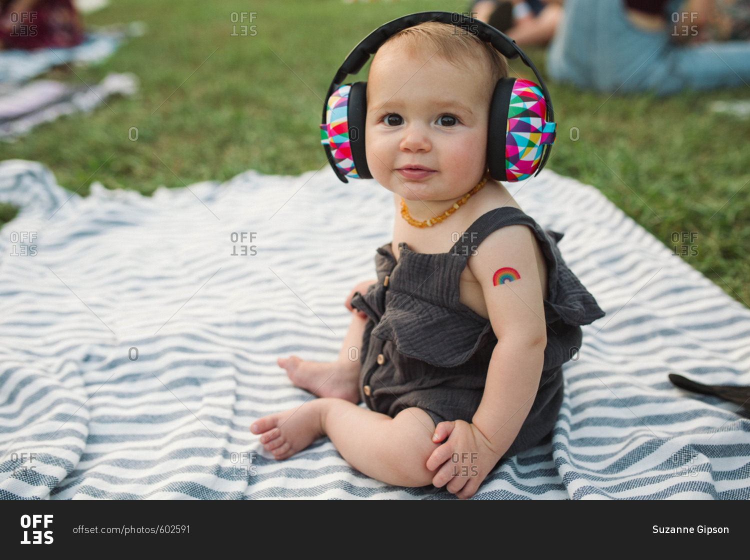 Baby with ear protectors at outdoor concert