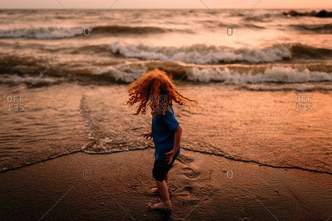 Child on beach during sunset