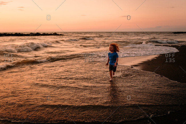 Child on beach during sunset