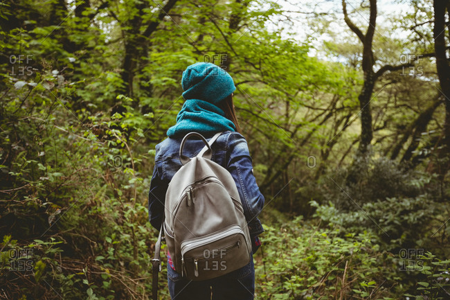 Woman hiking in countryside at forest