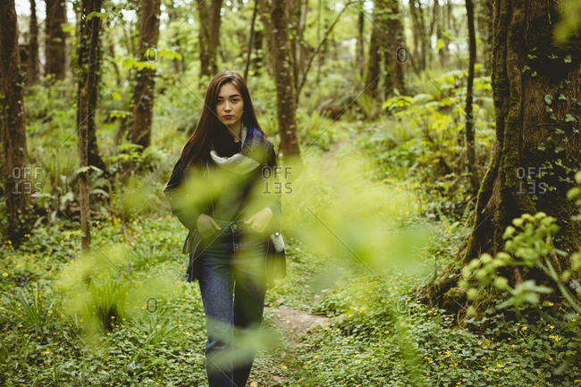 Woman hiking in countryside at forest
